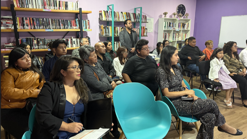 Personas reunidas en una sala.